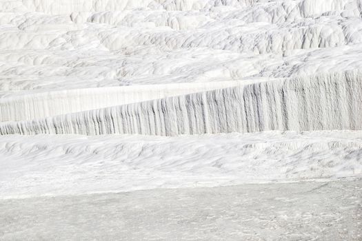 Background of white texture of Pamukkale calcium travertine in Turkey.