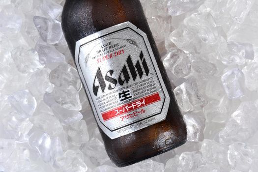 IRVINE, CA - JANUARY 11, 2015: A bottle of Asahi Super Dry Beer closeup on a bed of ice. Asahi was founded in Osaka, Japan in 1889 as the Osaka Beer Company.
