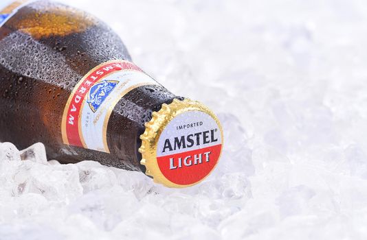 IRVINE, CA - AUGUST 26, 2016: A bottle of Amstel Light on a bed of ice. Founded in 1870 it was taken over by Heineken in 1968, produces over 36 million liters yearly.