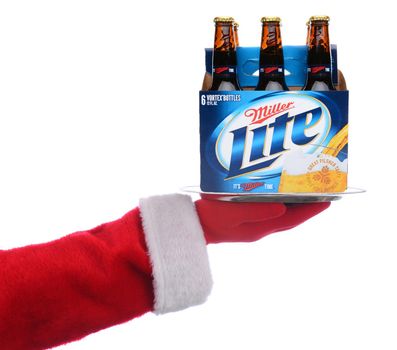 IRVINE, CALIFORNIA - 4 SEPT 2020: Santa Claus holding a serving tray with a 6 pack of Miller Light Beer over a white background.