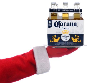IRVINE, CALIFORNIA - 4 SEPT 2020: Santa Claus holding a serving tray with a 6 pack of Corona Extra Beer over a white background.
