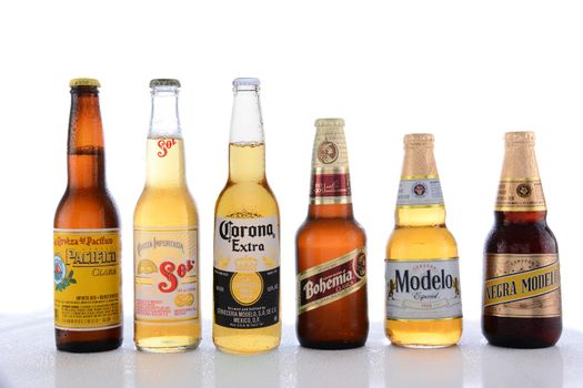 IRVINE, CA - JUNE 14, 2015: Popular Mexican Beers. Pacifico, Sol, Corona, Bohemia and Modelo beer bottles on a wet table with reflections. 