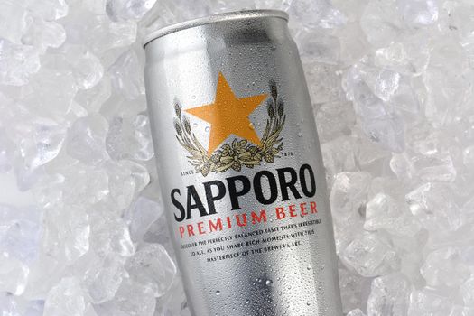 IRVINE, CA - JANUARY 12, 2015: A can of Sapporo Beer closeup on a bed of ice. The Japanese brewery was founded in 1876 by German trained brewer Seibei Nakagawa. It is the oldest beer brand in Japan.