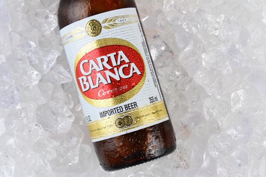 IRVINE, CA - JANUARY 11, 2015: A bottle of Carta Blanca Beer, closeup on a bed of ice. From Cerveceria Cuauhtemoc-Moctezuma, founded in 1890, now a subsidiary of Heineken International.