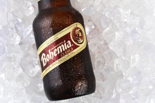 IRVINE, CA - JANUARY 12, 2015: A bottle of Bohemia beer on a bed of ice closeup. From Cerveceria Cuauhtemoc-Moctezuma, founded in 1890, now a subsidiary of Heineken International.