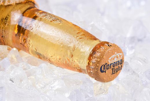 IRVINE, CALIFORNIA - DECEMBER 15, 2017: A bottle of Corona Light Beer on ice. Corona is the most popular imported beer in the USA.