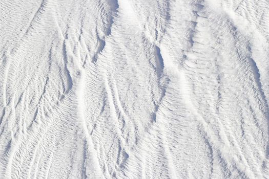 White texture of Pamukkale calcium travertine in Turkey, vertical pattern of the feathers close-up.