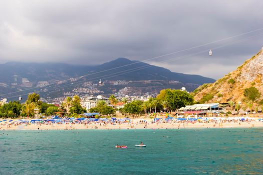 Turkey, Alanya, Cleopatra beach - August 30, 2017: Panorama of the beach on background of mountains, view from the sea.