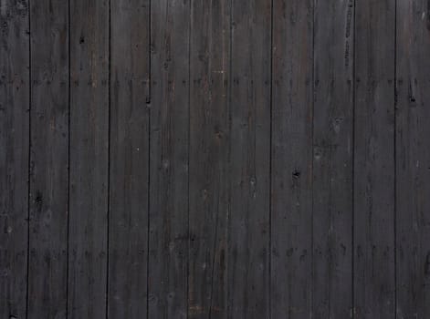 black background pattern of vertical wooden old grungy painted planks on old barn
