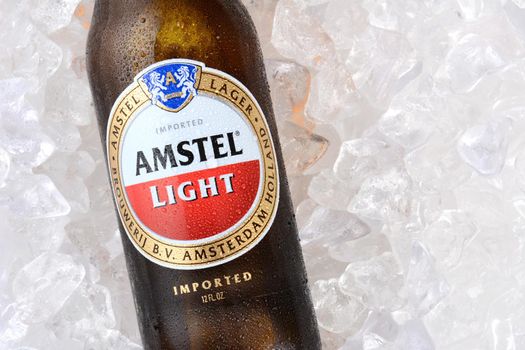 IRVINE, CA - JANUARY 11, 2015: A bottle of Amstel Light on a bed of ice. Founded in 1870 it was taken over by Heineken in 1968, produces over 36 million liters yearly.