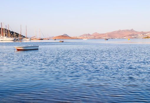 Beautiful sunrise on the Aegean Sea with islands, mountains and boats