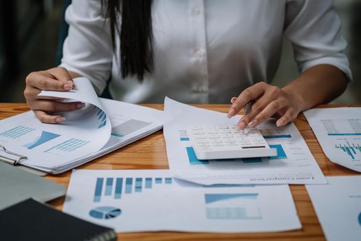 Close up woman calculating using machine managing household finances at home, focused biracial male make calculations on calculator paying bills, account taxes or expenses.