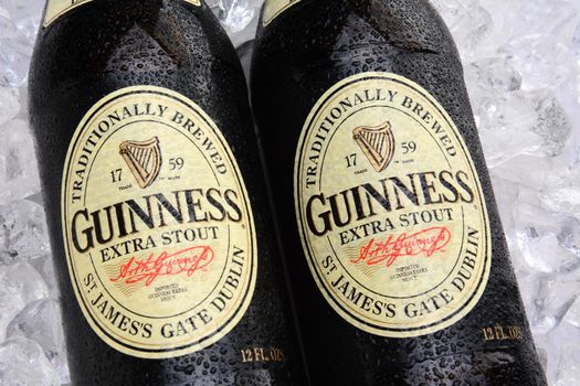 IRVINE, CA - MAY 25, 2014: Two bottles of Guinness Extra Stout on a bed of ice. The Irish beer is one of the worlds most successful beer brands with annual sales over 850 million liters.