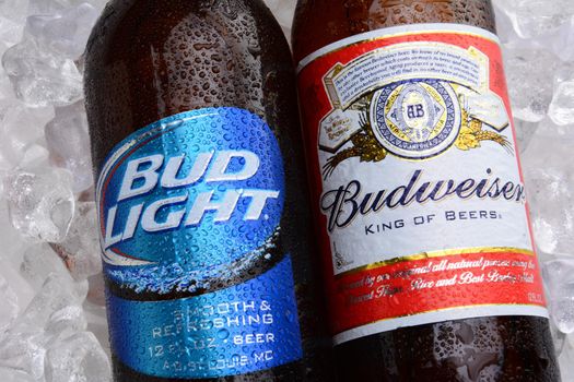 IRVINE, CA - MAY 27, 2014: A bottle of Budweiser and Bud Light on a bed of ice. From Anheuser-Busch InBev, Budweiser and Bud Light are top selling domestic beers in the United States.