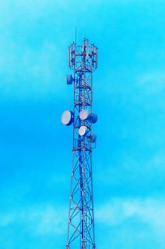 Mobile techology telecommunications network tower on a background of blue sky.