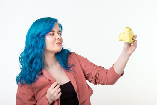 Photographer, hobby and leisure concept - Young blond woman with retro camera on white background with copy space.