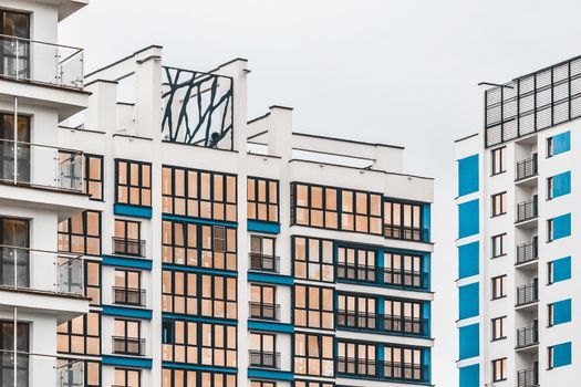 New modern high-rise apartment urban building exterior, facade of a residential city house.