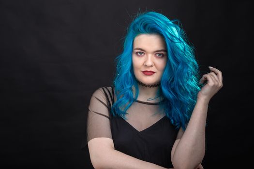 People, style and fashion concept - Close up portrait of young woman with blue long hair dressed in black dress.