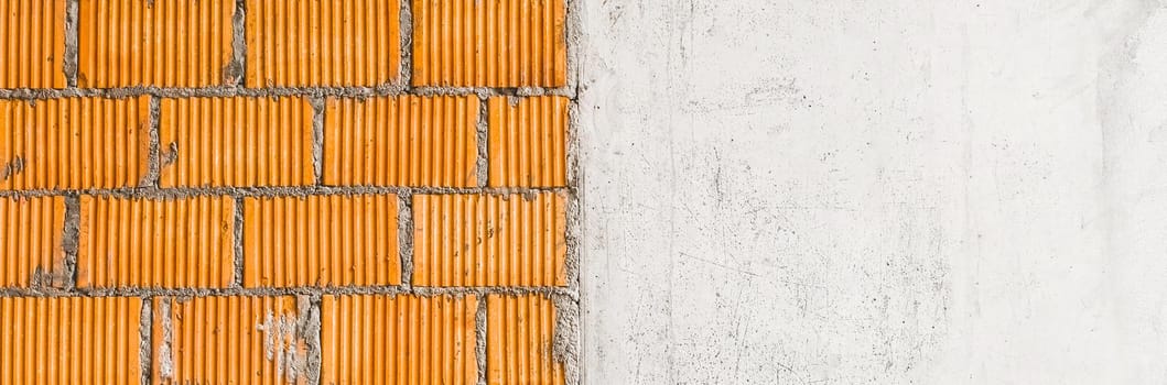 White scratched concrete wall and brown brickwork texture, construction building background.