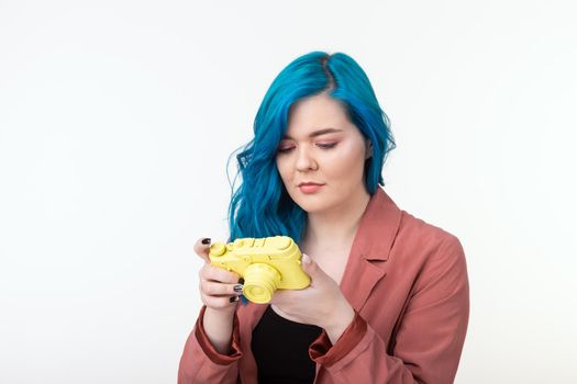 Photographer, hobby and leisure concept - Young blond woman with retro camera on white background with copy space.