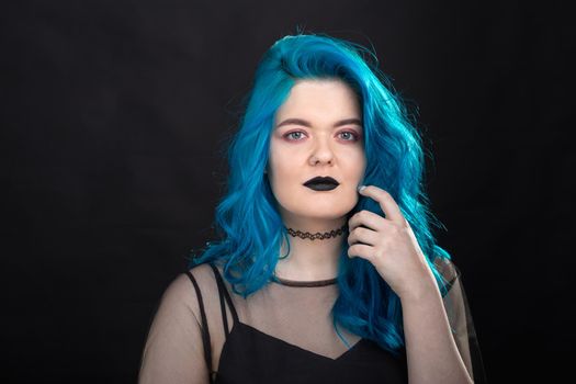 People, style and fashion concept - Close up portrait of young woman with blue long hair dressed in black dress.