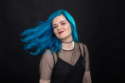 People, style and fashion concept - Close up portrait of young woman with blue long hair dressed in black dress.