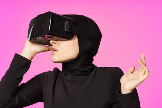 muslim woman wearing virtual reality glasses entertainment technology device. High quality photo