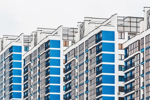 New modern high-rise apartment urban building exterior, facade of a residential city house.