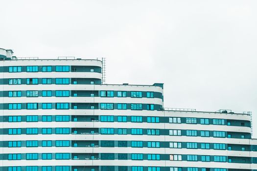 New modern high-rise apartment urban building exterior, facade of a residential city house.