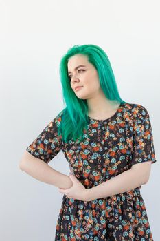 Fashion and people concept - Portrait of beautiful girl with green hair on a white background.