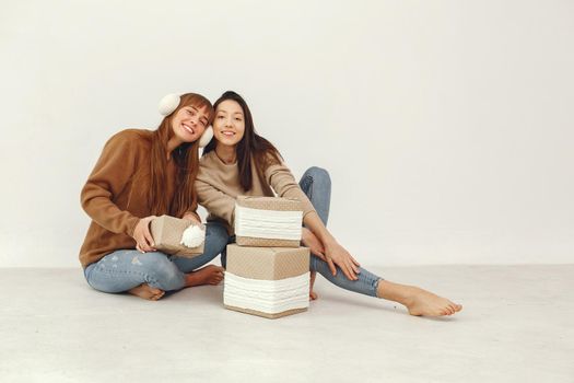 Women with presents. Girls in a brown sweater. Ladies in a studio.