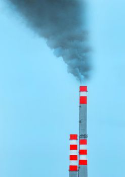 Environmental pollution, environmental problem, smoke from the chimney of an industrial plant or thermal power plant against a sky.