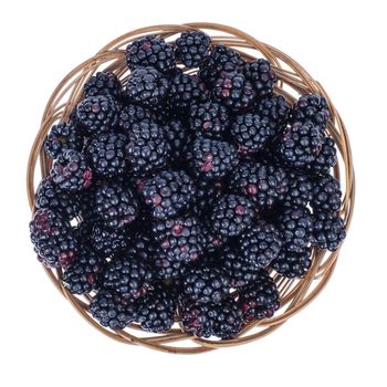 Ripe sweet black blackberries in wooden bowl. Studio Photo