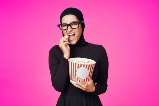 pretty woman attractive look popcorn glasses movie watching studio lifestyle. High quality photo