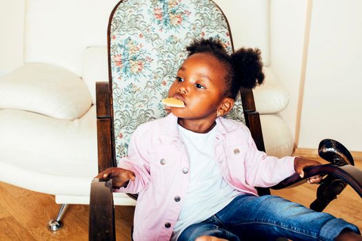 little cute african american girl playing with animal toys at home, pretty adorable princess in interior happy smiling, lifestyle real people concept close up
