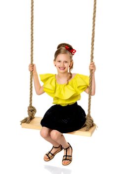 Happy little girl gaily swinging on a swing. The concept of a summer vacation in nature, a family vacation with the family on the beach or the sea. Isolated on white background.