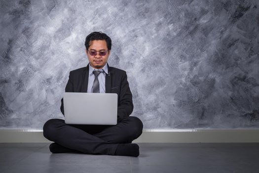 young business man sitting and using laptop 