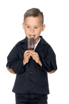 Cute little boy with appetite eating ice cream in the studio on a white background. The concept of proper nutrition, summer family vacations. Isolated.