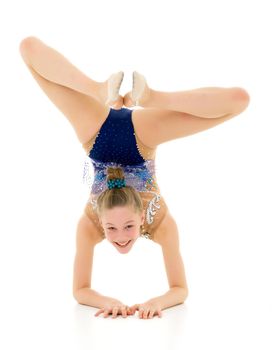 A girl gymnast performs an exercise stance on her forearms.The concept of childhood, sport, a healthy lifestyle. Isolated on white background.