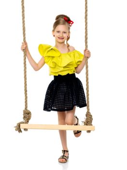 Happy little girl gaily swinging on a swing. The concept of a summer vacation in nature, a family vacation with the family on the beach or the sea. Isolated on white background.