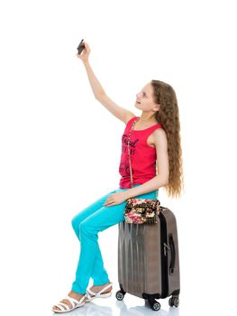 Happy smiling little girl making self-portrait on smartphone. The concept of people and technology. Isolated on white background.