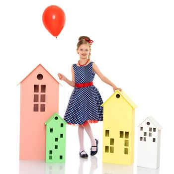 Little girl is playing with a balloon. The concept of the holiday, birthday. Isolated over white background