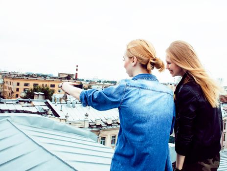 two cool blond real girls friends making selfie on roof top, lifestyle people concept, modern teens closeup