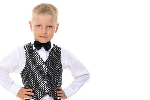 A cute little boy in a suit and a waistcoat with a butterfly. The concept can be used to advertise holidays, fashion shows. Isolated on white background.