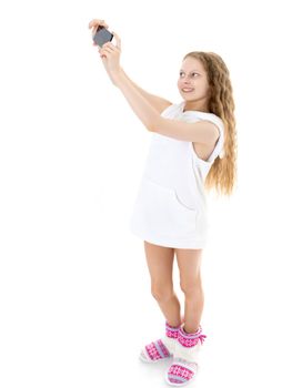 Happy smiling little girl making self-portrait on smartphone. The concept of people and technology. Isolated on white background.