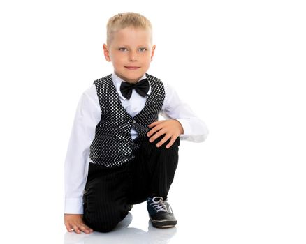 A cute little boy in a suit and a waistcoat with a butterfly. The concept can be used to advertise holidays, fashion shows. Isolated on white background.