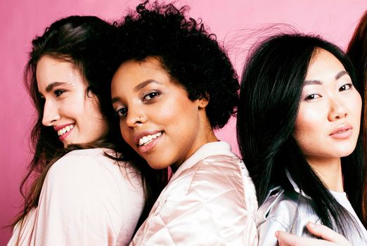 different nation girls with diversuty in skin, hair. Asian, scandinavian, african american cheerful emotional posing on pink background, woman day celebration, lifestyle people concept close up