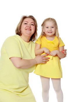 Mom and little daughter plus the size of the model, gently embrace. A woman and her daughter are smiling in a happy manner. Good for the concept of health, happiness, diet, obesity, weight loss.