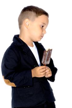 Cute little boy with appetite eating ice cream in the studio on a white background. The concept of proper nutrition, summer family vacations. Isolated.