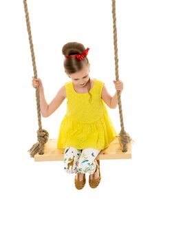 Happy little girl gaily swinging on a swing. The concept of a summer vacation in nature, a family vacation with the family on the beach or the sea. Isolated on white background.